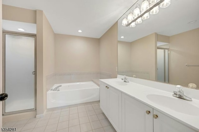 full bath with tile patterned floors, a sink, a garden tub, and a stall shower