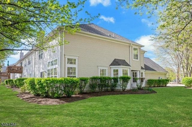 back of house with a lawn