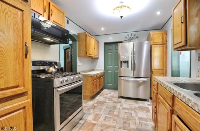 kitchen with light countertops, a sink, and stainless steel appliances