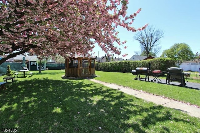 surrounding community featuring fence and a yard