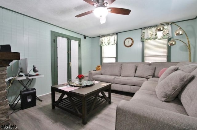 living area featuring ceiling fan and light wood finished floors