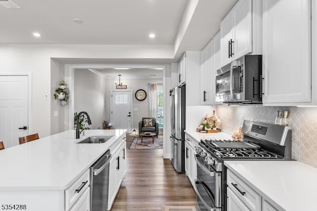 kitchen featuring a sink, light countertops, a kitchen island with sink, and stainless steel appliances