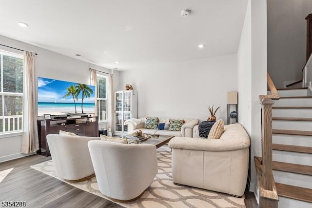 living area featuring light wood-style floors, stairway, and recessed lighting