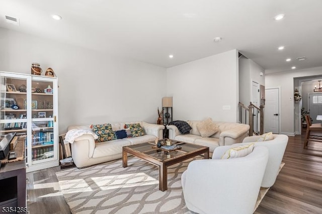living area with recessed lighting, visible vents, and wood finished floors