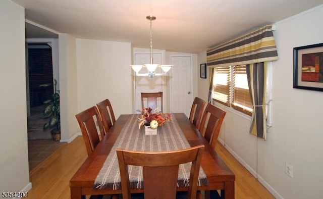 29 Olcott St, Franklin Twp, NJ 08873 - dining space featuring baseboards, an inviting chandelier, and wood finished floors