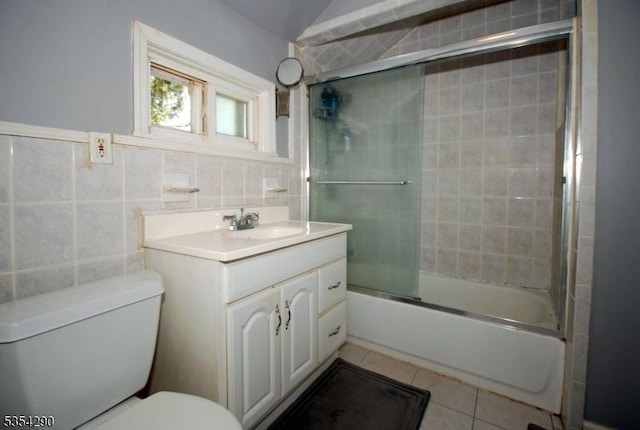 29 Olcott St, Franklin Twp, NJ 08873 - full bathroom featuring tile patterned flooring, vanity, toilet, tile walls, and bath / shower combo with glass door