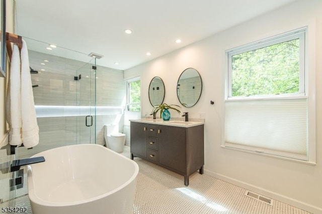 full bath featuring visible vents, double vanity, a stall shower, and a healthy amount of sunlight
