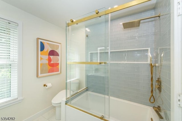 bathroom with bath / shower combo with glass door, a wealth of natural light, and toilet