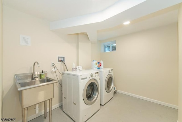 laundry room with baseboards and washer and clothes dryer