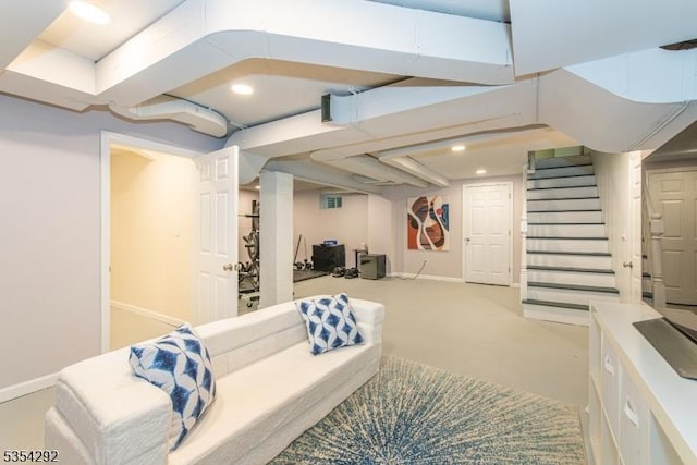 finished below grade area featuring baseboards, recessed lighting, stairs, and light colored carpet
