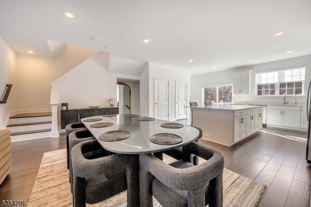dining area with recessed lighting, dark wood-style floors, and stairway