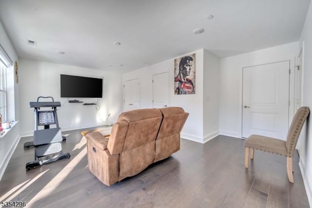 living room with baseboards, dark wood-style flooring, and visible vents