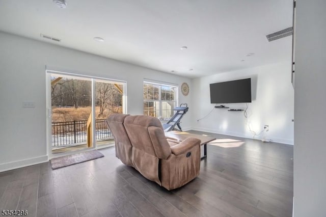 living area with baseboards, dark wood-style flooring, and visible vents