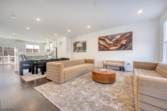 living room featuring recessed lighting, baseboards, and wood finished floors