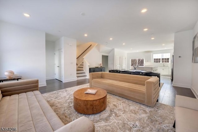 living area with stairway, baseboards, recessed lighting, and wood finished floors