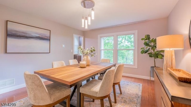 dining room featuring baseboards and light wood finished floors