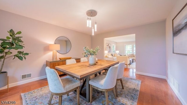 dining space with wood finished floors and baseboards