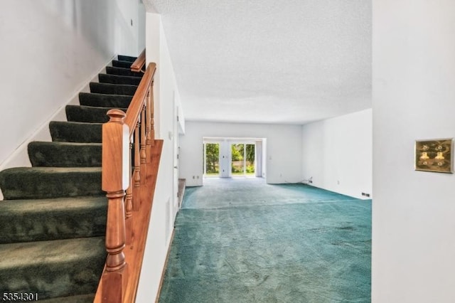 unfurnished living room featuring carpet, stairway, and french doors