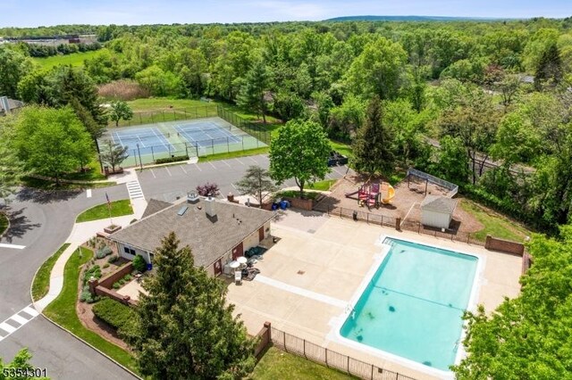 bird's eye view of a forest and a pool area