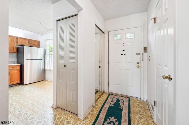 foyer entrance with a textured ceiling
