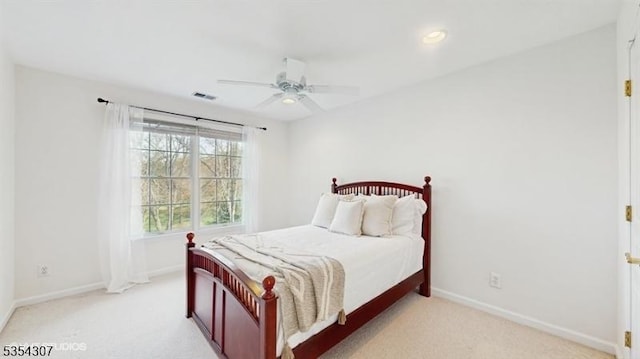 bedroom featuring baseboards, visible vents, and light carpet