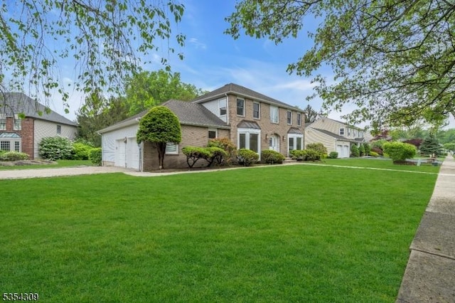 view of front of home featuring a front lawn, a garage, driveway, and brick siding