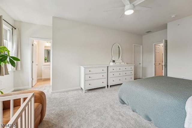 bedroom with light colored carpet, connected bathroom, baseboards, and visible vents