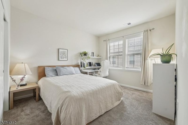 bedroom with baseboards, visible vents, and carpet