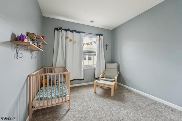 bedroom with visible vents, carpet, baseboards, and a nursery area