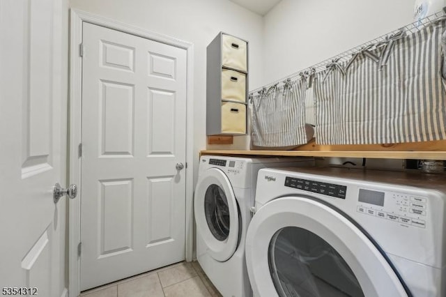 laundry area featuring laundry area, light tile patterned flooring, and separate washer and dryer