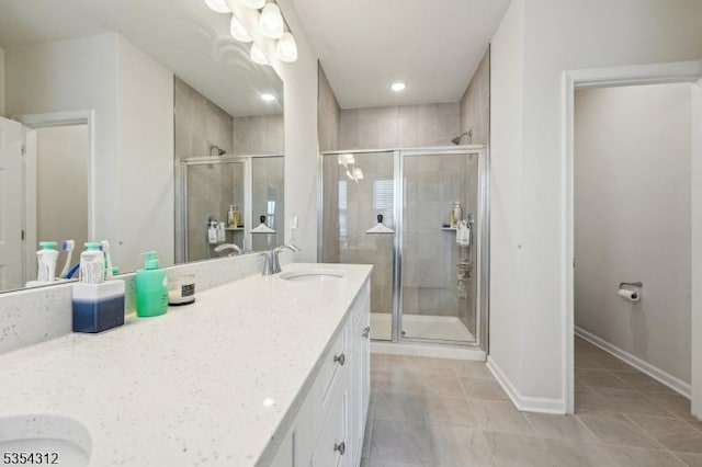 bathroom with a sink, tile patterned floors, a shower stall, and double vanity