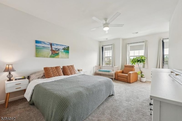 bedroom with baseboards, carpet, a ceiling fan, and visible vents