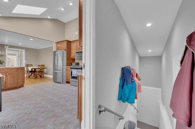 interior space featuring recessed lighting, a skylight, light tile patterned floors, and high vaulted ceiling