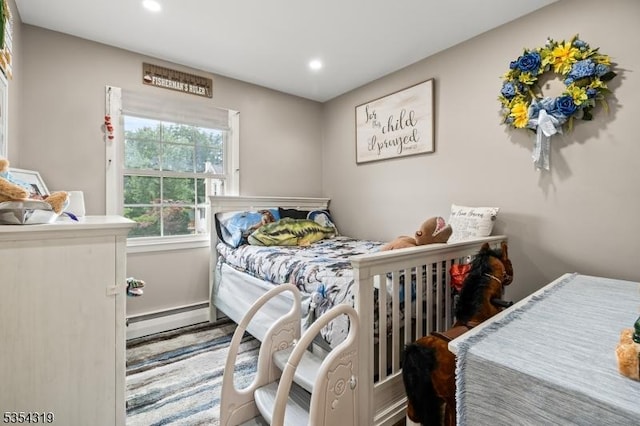 bedroom featuring recessed lighting and a baseboard heating unit