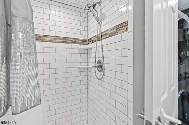 bathroom with tiled shower