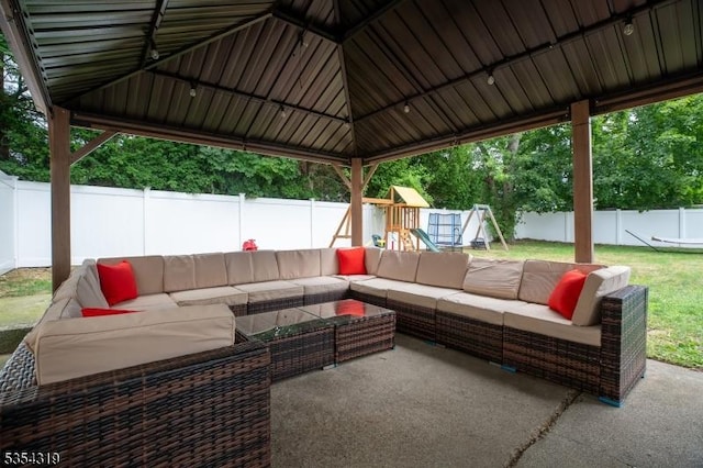 view of patio / terrace with an outdoor living space, a fenced backyard, and a playground