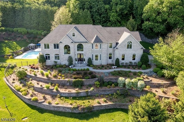 37 Gregory Ave, West Orange Twp, NJ 07052 - french provincial home with a forest view, an outdoor pool, and stone siding