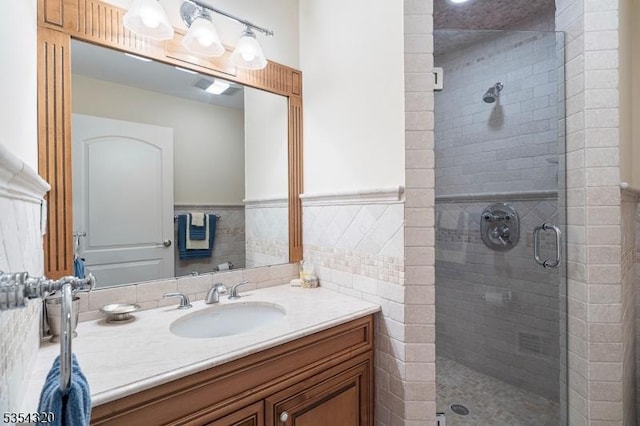 37 Gregory Ave, West Orange Twp, NJ 07052 - bathroom featuring a stall shower, vanity, wainscoting, and tile walls