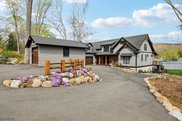 view of front of home with an attached garage, fence, and driveway