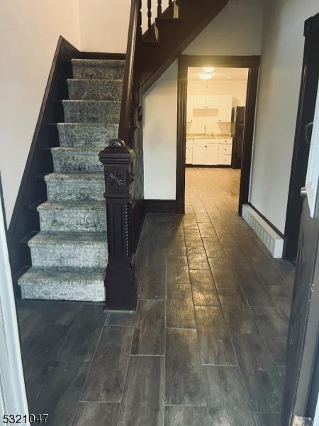stairs with hardwood / wood-style flooring
