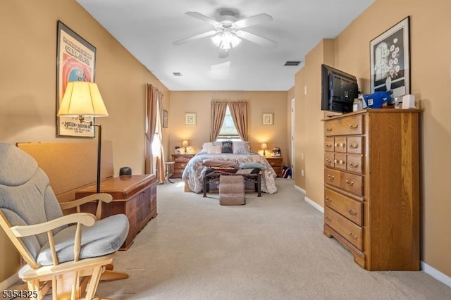 bedroom with baseboards, visible vents, and light colored carpet