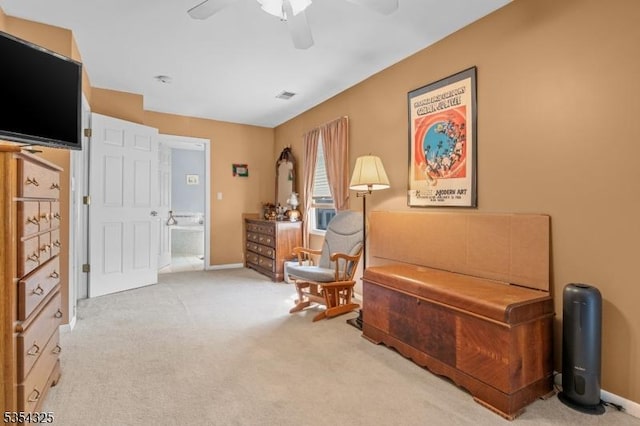 sitting room featuring a ceiling fan, baseboards, and carpet