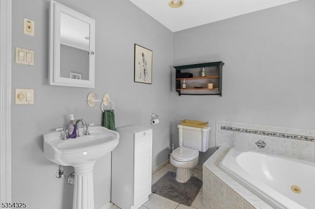 full bath featuring tile patterned floors, baseboards, a garden tub, and toilet