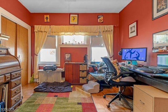 office area with a healthy amount of sunlight and radiator heating unit