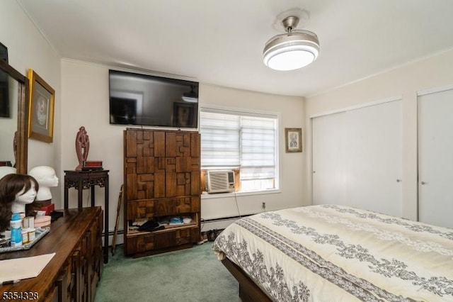 bedroom featuring carpet flooring, crown molding, baseboard heating, and multiple closets