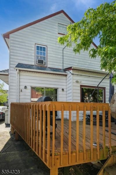 back of house featuring a wooden deck