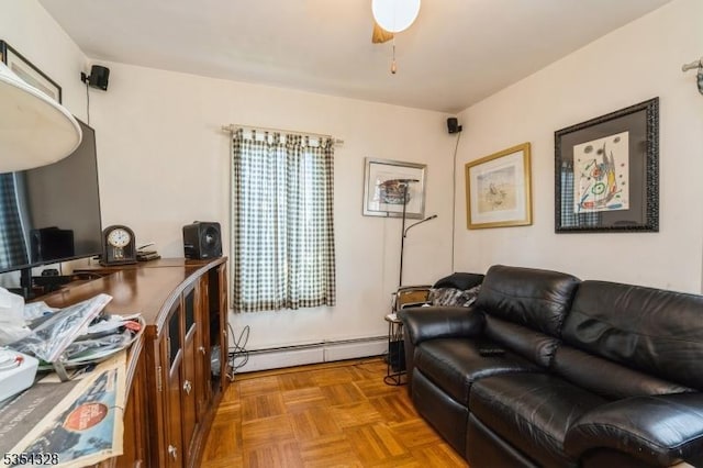 living area with ceiling fan and a baseboard heating unit