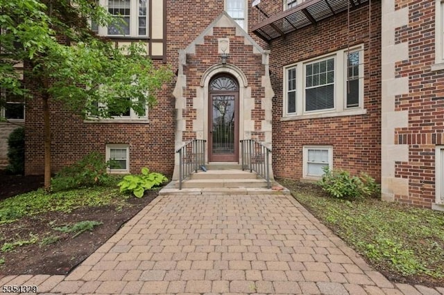 view of exterior entry with brick siding