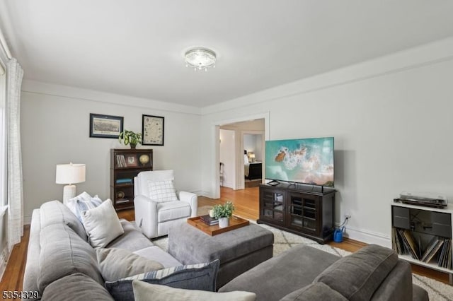 living area with wood finished floors and baseboards