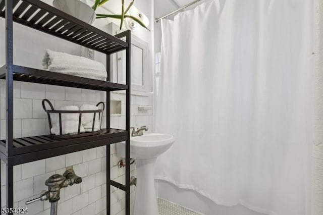 full bathroom featuring backsplash